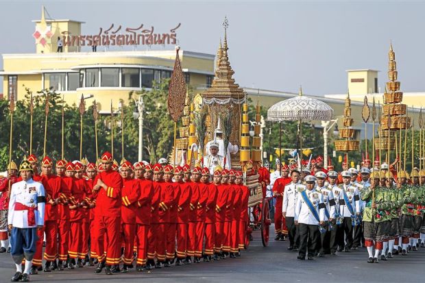 Final journey: Officials marching with the royal carriage containing the remains of the Supreme Patriarch during his cremation ceremony in Bangkok.  Reuters