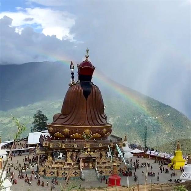 An auspicious rainbow crowns the statue of Guru Rinpoche in Takila during the empowerments From Dzongsarjamyangkhyentsefanclub Facebook